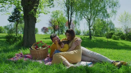Loving Family Enjoying a Sunny Picnic in Park