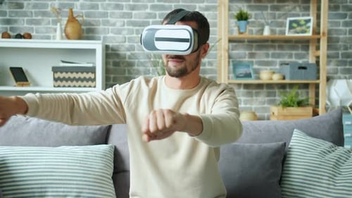Man Using Virtual Reality Headset on Couch
