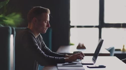 Beautiful Male Developer or Student Working Studying By Laptop in Cafe