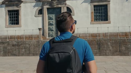 Man Traveler with Backpack Relaxing Outdoor Sea and Rocks Coastal on Background Freedom Lifestyle