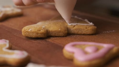 Decorating Gingerbread Cookies in the Shape of Christmas Tree with Royal Icing