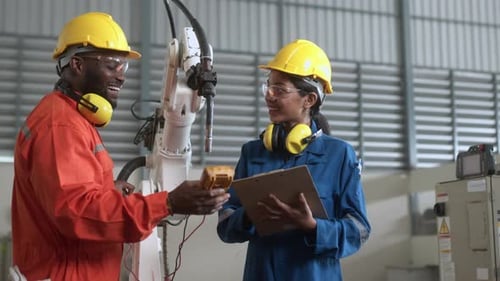engineer cooperation male and female technician maintenance control relay robot arm system welding