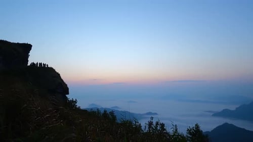 4K : Sunrise over the high mountains with the mist slowly flowing in the morning