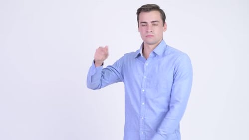 Young Happy Handsome Businessman Snapping Fingers and Showing Something
