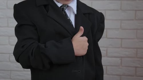 Girl Wearing Suit Jacket Puts Hand on Heart
