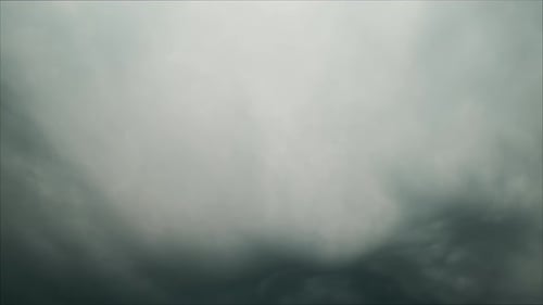 Tilting Shot From Dark Cloudy Skies To Beach with a View of the Ocean