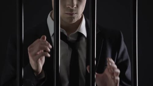 Politician Holding Prison Bars, Official Male Arrested on Money Laundering