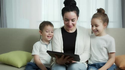 Happy Family Using Tablet on Couch