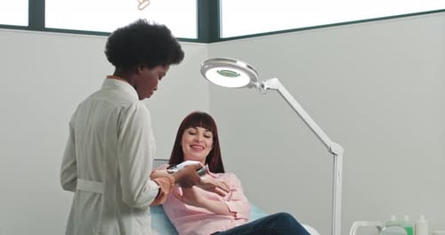 Doctor Using Device on Patient in Examination Room