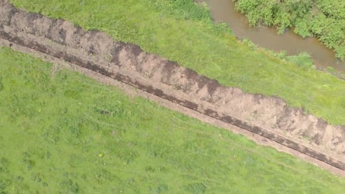 Aerial View of Trench Through Grassy Field