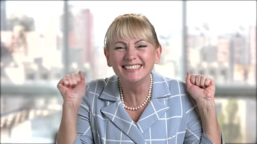Excited Woman Cheering for Success Indoors