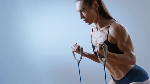 Female Athlete Doing Arm Exercises with Resistance Band