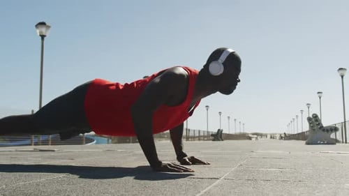 Athletic Man Doing Push Ups on Pier