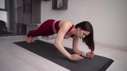 Woman Doing Plank Exercise on Yoga Mat at Home