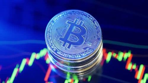 Silver Bitcoins on Blue Reflective Graph Background