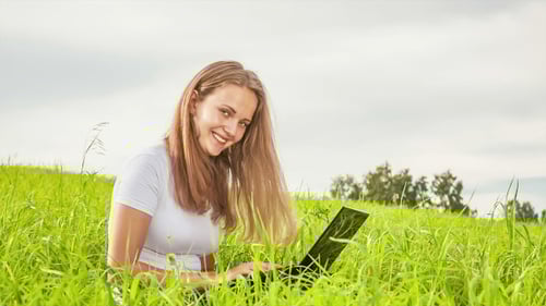 Women With Laptop on Green Meadow