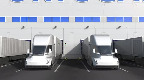 Electric Trucks at Warehouse Dock with PRODUCT OF PORTUGAL Text