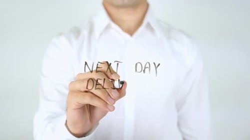 Man Writes Next Day Delivery on Glass