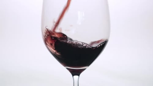 Pouring Red Wine into a Glass in Studio