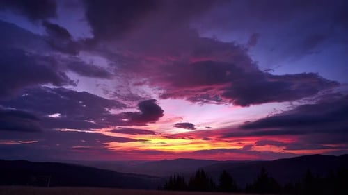Beautifully colored clouds before sunrise over the landscape, blue hour, 4K