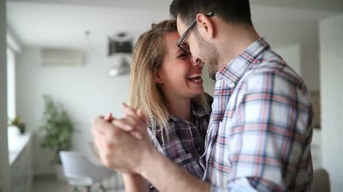 Affectionate Couple Dancing Together in Living Room