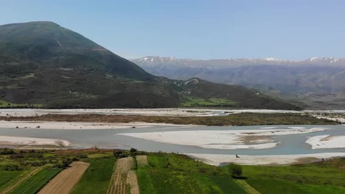 Aerial Drone Footage View Flight Over Mountain with Forests Fields and River in Sunrise Soft Light