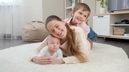 Smiling Family Lying Together on a Fluffy Rug