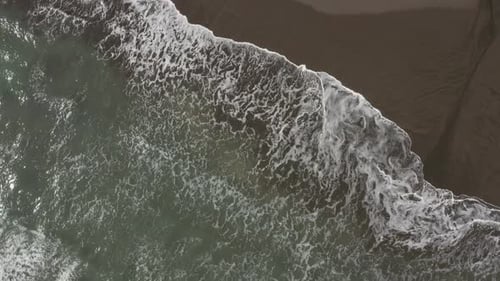 Drone view of waves on the beach