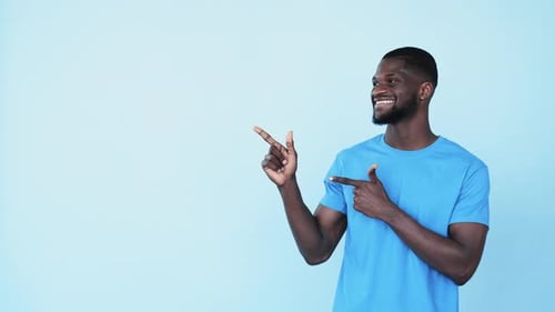 Smiling Man Gesturing to Copy Space