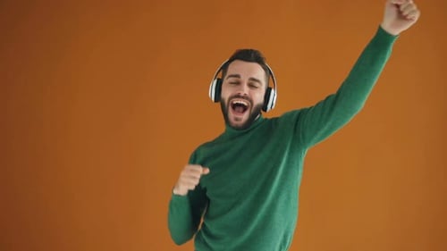 Enthusiastic Young Adult Dancing with Headphones