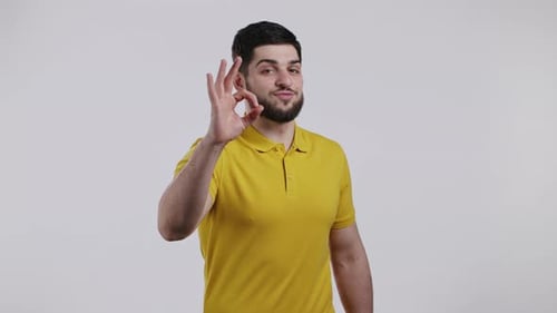Man Makes Okay Hand Gesture Smiling at Camera
