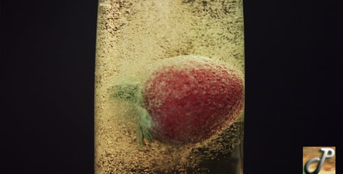 Strawberry Falls into Sparkling Drink with Bubbles