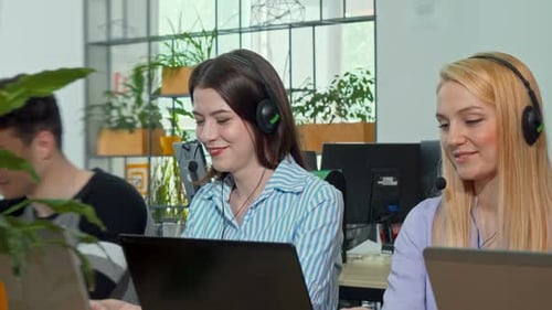 Adults Working on Laptops in a Modern Office