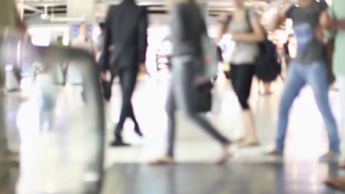 Blurred People Walk on Airport Moving Walkway