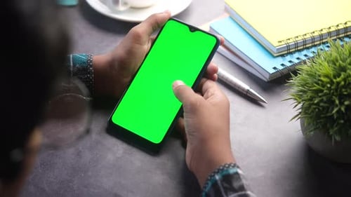 Rear View of Men Hand Using Smart Phone on Office Desk