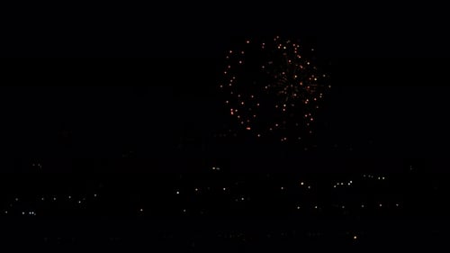 Fireworks Exploding Over a City at Night