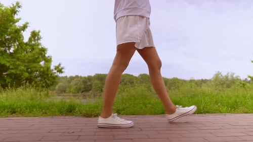 b Roll Legs Woman Stroll on Pavement in Park