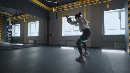 Crossfit Fitness TRX Training Exercises at Gym Woman Pushup Workout