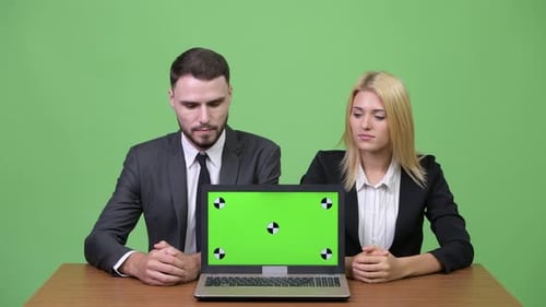 Business Team with Laptop Green Screen at Desk