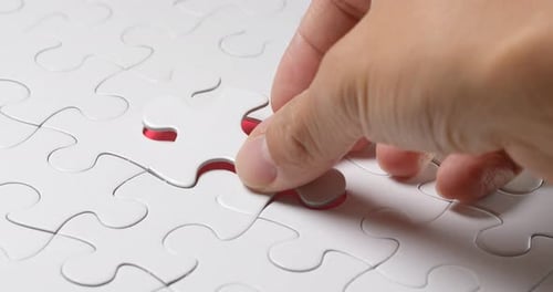 Hand Put the Last Piece of Jigsaw Puzzle to Complete the Mission
