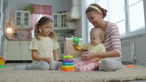 Mother Playing with Two Daughters at Home