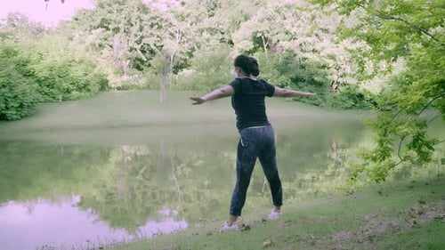 Asian woman exercise in park outdoor with new normal in COVID-19 situation