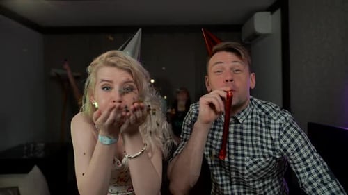 Friends Celebrating a Birthday With Glitter and Noisemakers