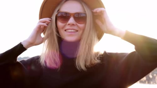 Woman Smiling and Posing Outdoors in Sunlight