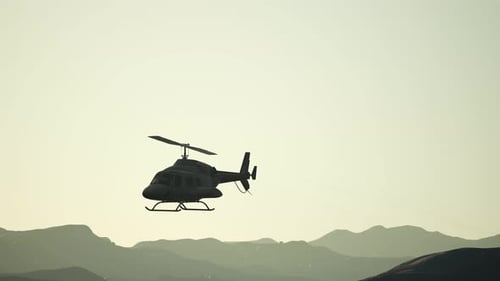 Realistic Helicopter Flying Over Mountain Range at Sunset
