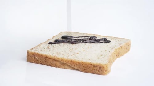 Chocolate Syrup Drizzled on Slice of Bread