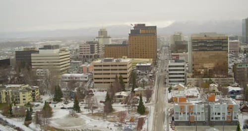 Helicopter aerials shot moving over green mountains, cloudy day
