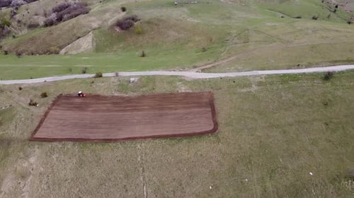 Tractor Tilling Soil in a Farm Field