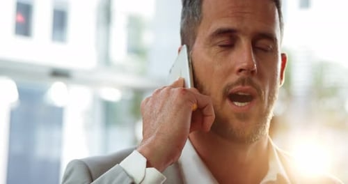 Man Talking on Smartphone in Modern Office Building