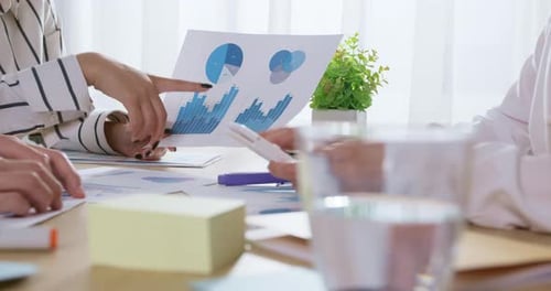 People Working at Table Reviewing Documents